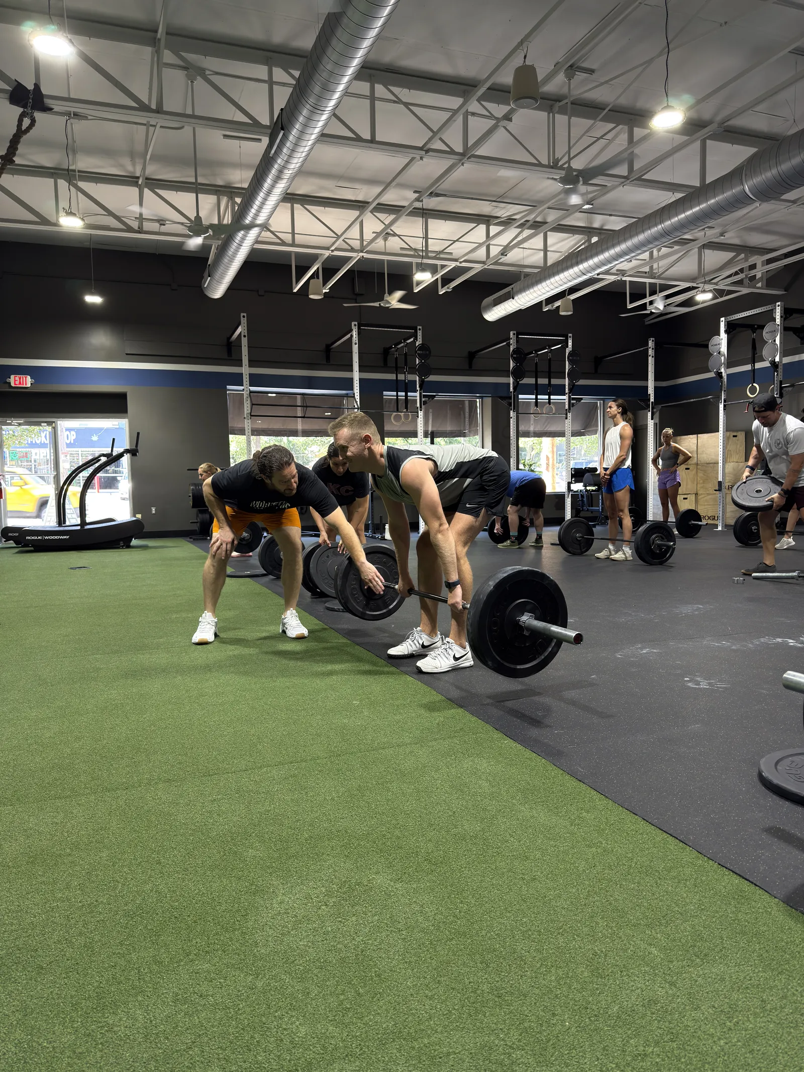 Athletes deadlifting in a coach-led CrossFit class at Work Ethic KC in Kansas City, MO