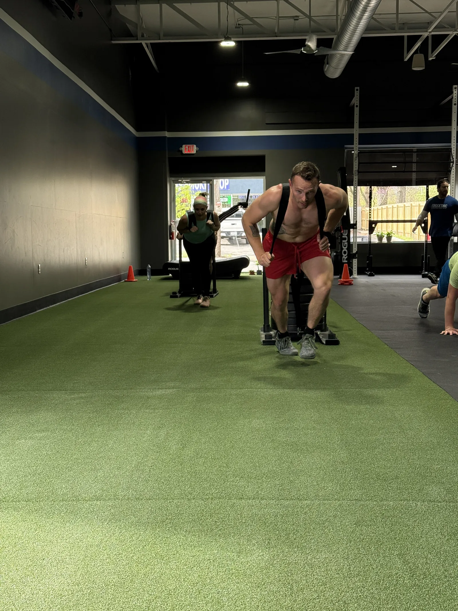 Athlete pushing a sled in a small group session at Work Ethic KC in Kansas City, MO